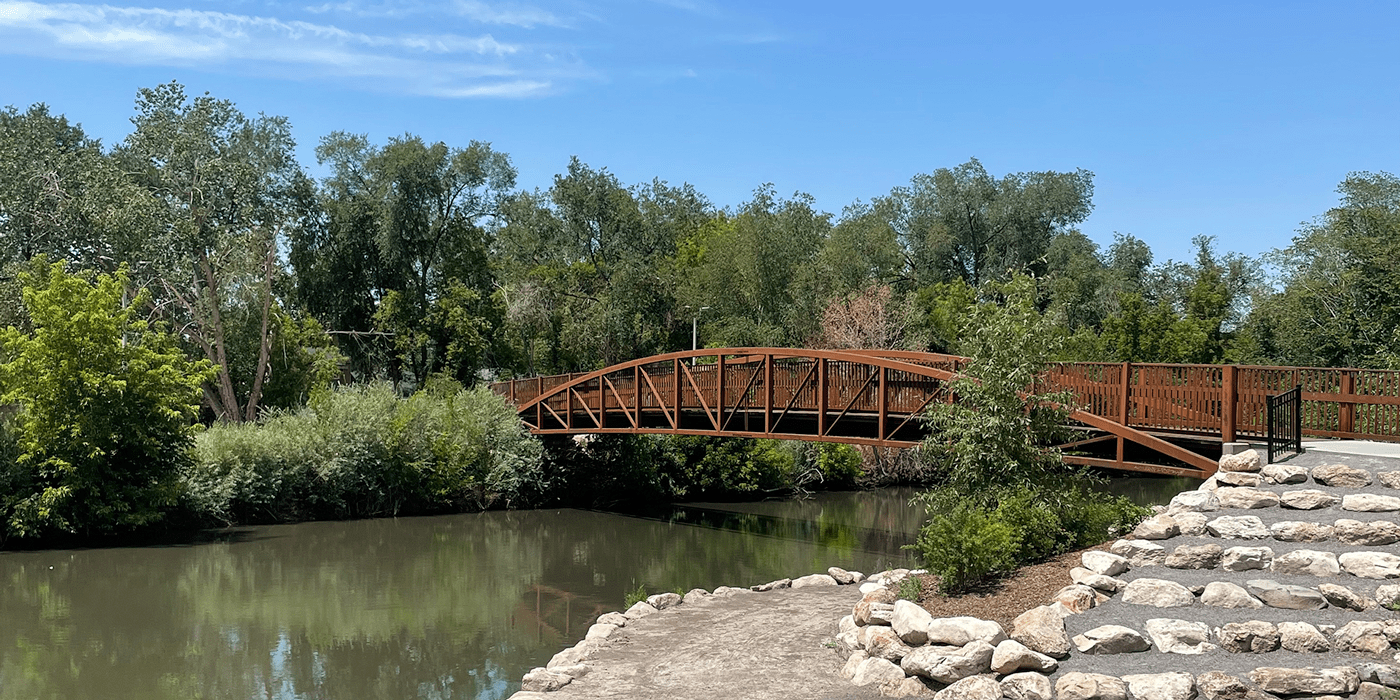 bridge over river with trees around it